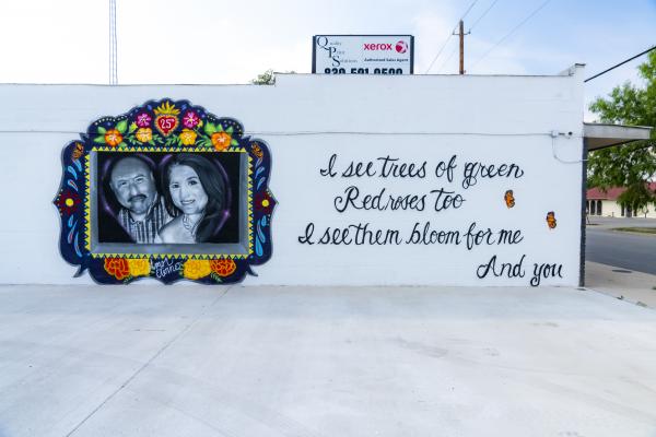 Color photo of portrait mural of Irma and Joe Garcia.