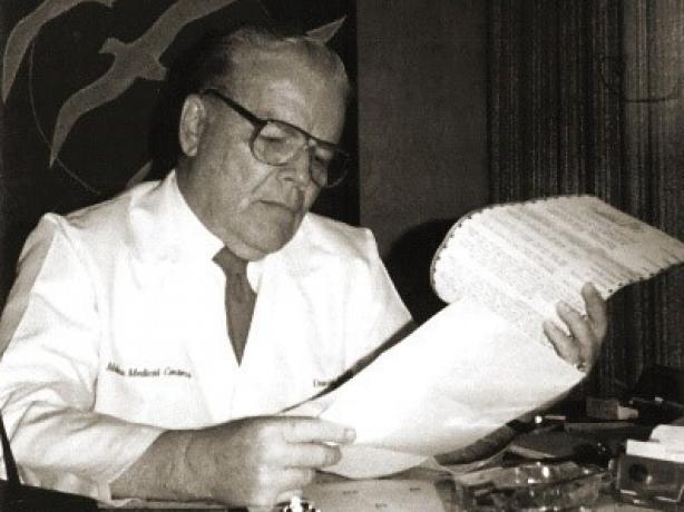Dr. C. David Molina reading document
