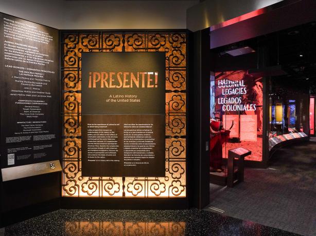 Entrance to museum exhibit Presente with introductory wall text