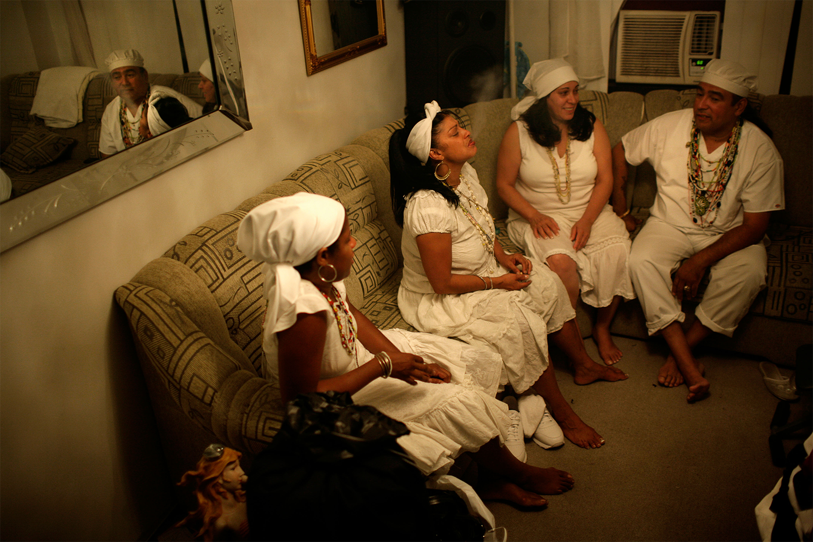 00642-D2-2021.09.29.png Color photo of four family members dressed in white after a Santeria ceremony.
