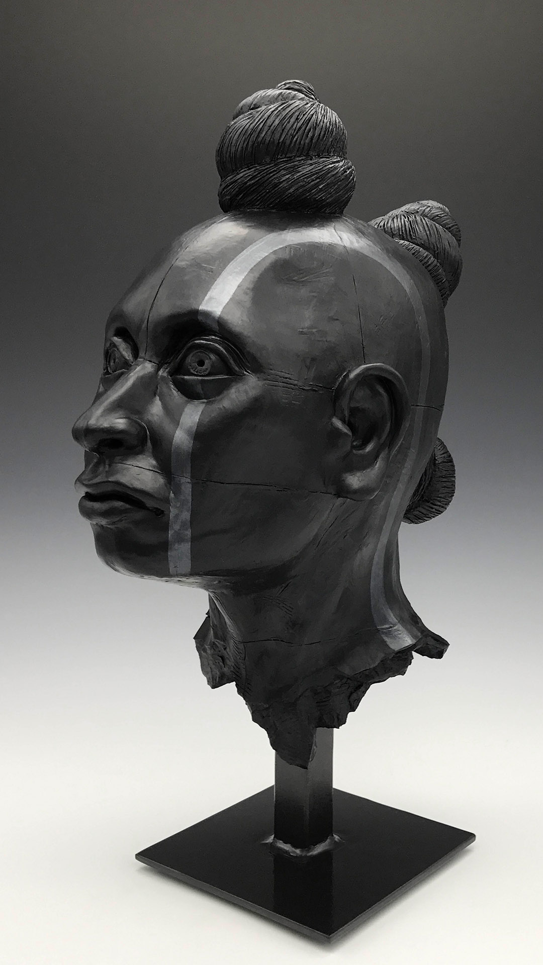 00717-D1-2021.09.30_01.jpg Color photo of black stone carving of Po’Pay’s head.