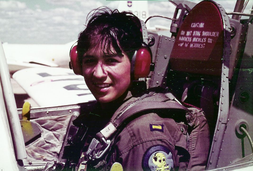 Olga E. Custodio Photo of Olga E. Custodio sitting in an airplane and looking at the camera.