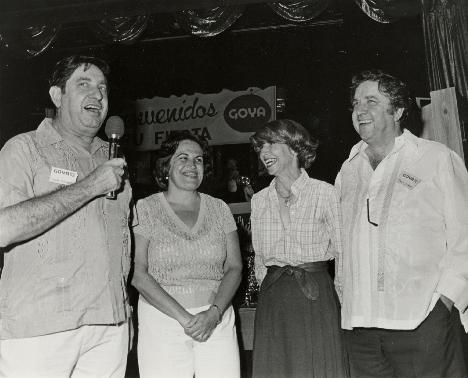 Goya Foods Group of people during a GOYA Foods public event. One of them speaks into a microphone.