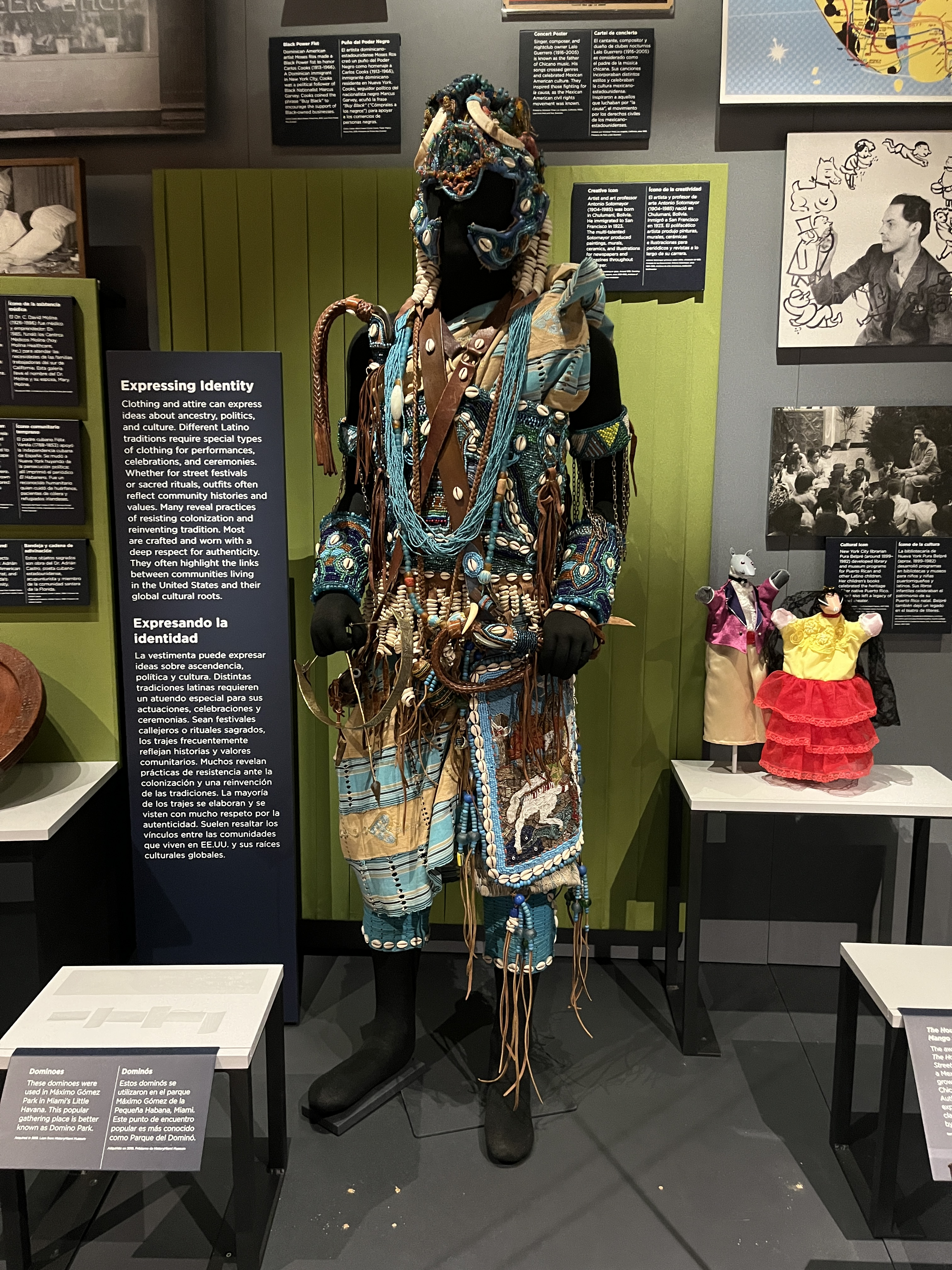 L2-0002206-D1-2023.05.22 Intricately decorated ritual outfit and headpiece with blue beads, cowrie shells, and leather.