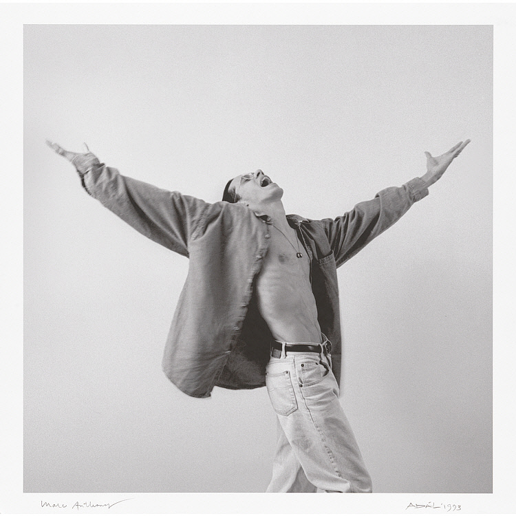 Marc Anthony Portrait of singer Marc Anthony with his arms outstreched while singing.